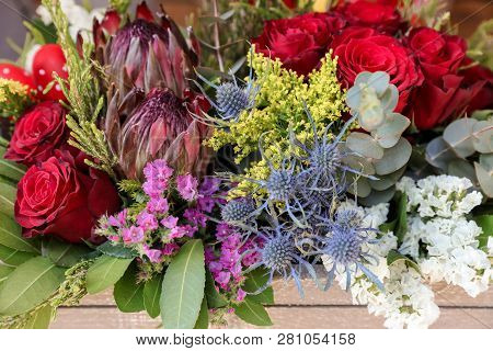 Easter Decor. Festive Flower Arrangement Of Protea, Red Roses, Limonium Sinuatum, Eryngium, Eucalypt