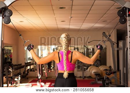 A Young Woman In The Gym Rocking The Back