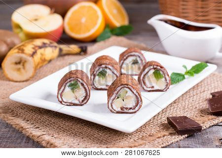 Homemade Pancakes Or Russian Blini With Chocolate Sauce On Plate On Rustic Wooden Background