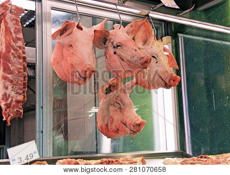 Severed Pig Heads Hanging In The Huge Covered Athens Central Public Market, Dimotiki Agora Meat And 