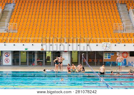 Poznan, Poland - January 26, 2019: People At A Swimming Pool With A Empty Tribune In The Termy Malta
