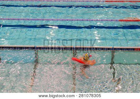 Poznan, Poland - January 26, 2019: Young Boy Exercising His Swimming Skills With A Swim Stick During