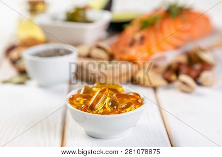 Selection Of Healthy Unsaturated Fats, Omega 3 - Fish, Avocado, Olives, Nuts And Seeds Vs Pills