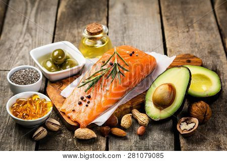 Selection Of Healthy Unsaturated Fats, Omega 3 - Fish, Avocado, Olives, Nuts And Seeds