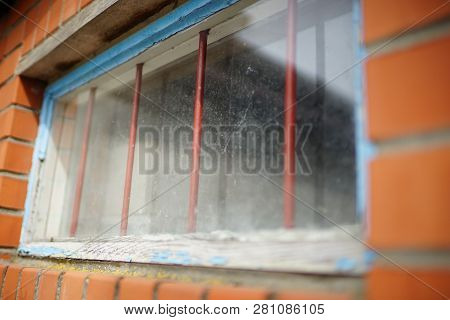 Small Window With A Lattice In A Brick Building