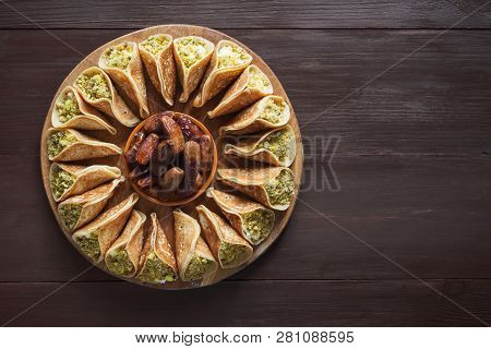 Arab Sweets. Arabian Pancake Stuffed With Sweet Cheese And Pistachios.