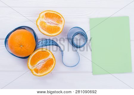 Healthy Food And Weight Loss Concept. Fresh Orange Fruits, Tape For Figure Measuring And Blank Paper