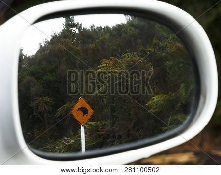 Kiwi Road Sign Reflected In A Car Mirror