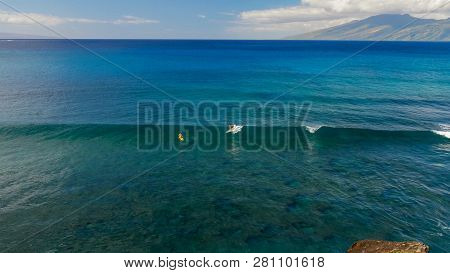 A Surfer Rides A Longboard At Honolua Bay, Maui In Hawaii