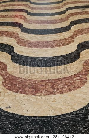 Detail Of The Floor Made Of Marble Tesserae Of Red, Black And White Forming A Wavy Mosaic In The Esp