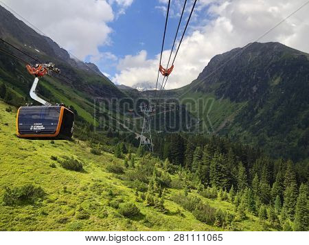 TYROL, AUSTRIA - JULY 2018 : Stubaier Gletscher gondola lift approaching station at Stubai Glacier in Tyrol, Austria on July 26, 2018. 