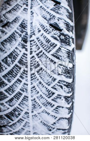 Close Up Car Tires Covered With Snow. Winter Tyres In Extreme Cold Temperature