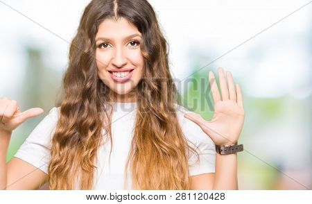 Young beautiful woman wearing casual white t-shirt showing and pointing up with fingers number six while smiling confident and happy.