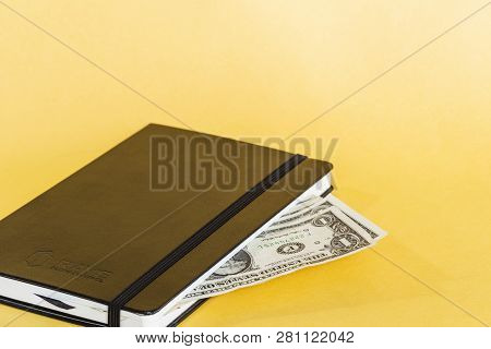 Dollars Inside Of The Notepad. Corruption Conceptual Photo.