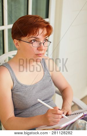 Pondering Attractive Caucasian Woman With Pen In Hand Thinking On Plans And Writing List To Do In No