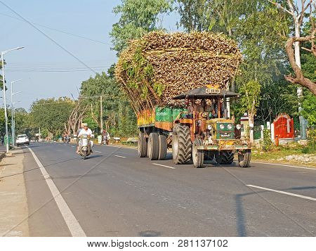 Tiruvanamalai, India - January 4, 2019: Tractor full of wood driving in the countryside from India