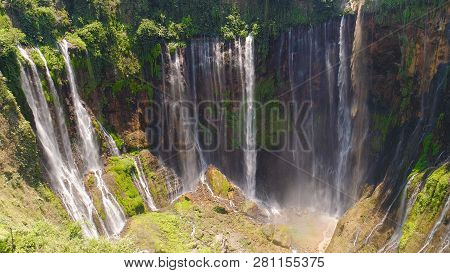 Aerial View Waterfall Coban Sewu In Java, Indonesia. Waterfall In Tropical Forest By Drone Tumpak Se