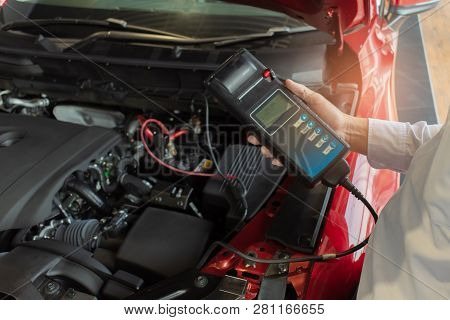 Man Inspection Holding Battery Capacity Tester Voltmeter.for Service