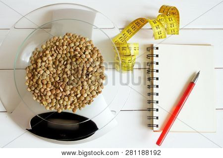 Counting Calories, Proteins, Fats And Carbohydrates In Food. Lentil Grains On Table Scales. Slim Fig