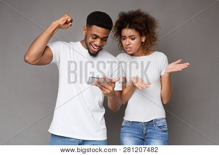 Excited Man Rejoice Winning, Made Bets On Website Or Application, Annoyed Woman Looking With Bewilde