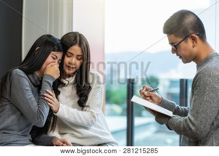 Asian Male Professional Psychologist Doctor Giving The Consult To Lesbian Lovers Patients Which Have