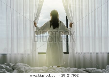 Back Side Of Asian Woman In Bathrope Suit When Waking Up From The Bed In Luxury Hotel In Morning, Li