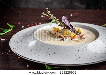 American Cuisine Concept. American Soup Clam Chowder With Chicken Broth And Milk, With Bacon And Mus
