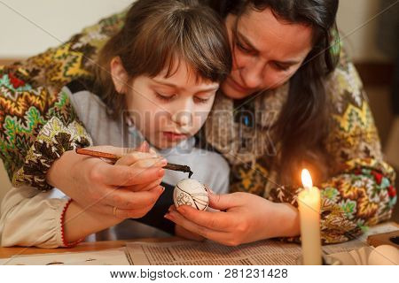 Lviv, Ukraine - March 11, 2018. Mom And Daughter Paint Easter Eggs At The Table