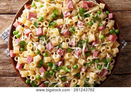 Traditional Italian Pasta Ditalini With Green Peas, Ham And Cheese Closeup On A Plate. Horizontal To