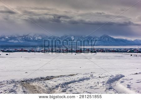 Winter Village View. Snow Covered Mountains. Moubtains, Buildings