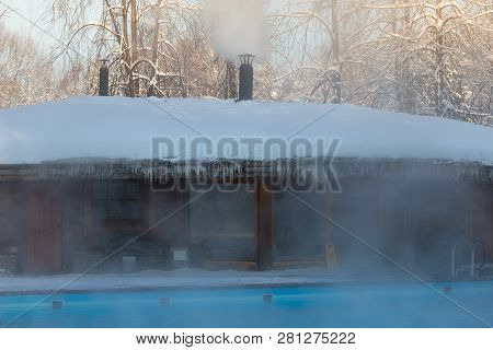 Warm Swimming Pool With Blue Water And Wooden Russian Bath In Frosty Weather, Outdoor.