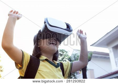 Children Wearing Virtual Reality Glasses With Fun And Surprising Face Standing  Outdoor