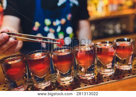 Bartender Man Making Hot Alcohol Shots On The Bar In The Pub With A Professional Burner. The Bartend
