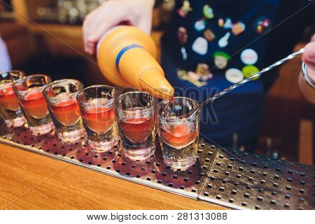 Bartender Man Making Hot Alcohol Shots On The Bar In The Pub With A Professional Burner. The Bartend