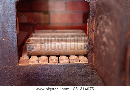 Bread Tins In A Vintage Brick And Iron Oven