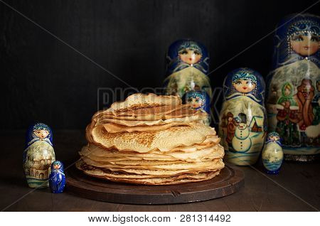 Stack Of Russian Pancakes Blini And Traditional Wooden Dolls Matrioshka