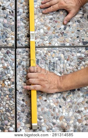 Craftsman Controls Whether Freshly Laid Floor Tiles Are In The Water, Male Hands With Spirit Level O