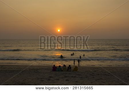 Querim, Goaindia - 9.12.2018. Big Indian Family On The Beach At Sunset Time. Women In Colorful Saree