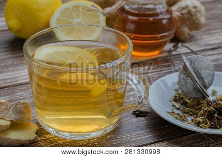 Natural Ginger Herbal Tea In A Glass Cup And A Lternative Remedies To Treat Cold And Flue: Ginger, L
