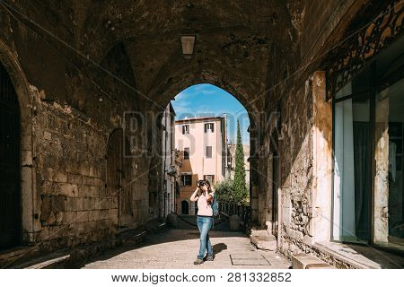 Terracina, Italy. Young Caucasian Woman Taking Photos In Gothic Palazzo Venditti.