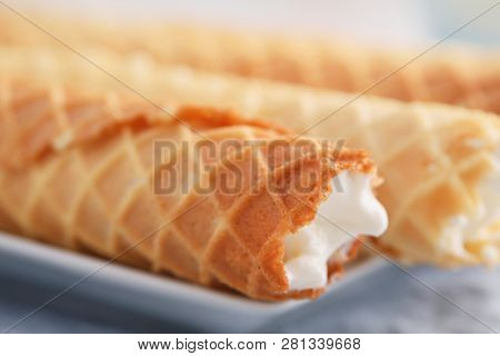 Gaufres de Montcuq, rolled wafers with cream filling  on a white dish