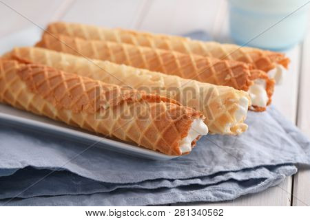 Gaufres de Montcuq, rolled wafers with cream filling  on a white dish