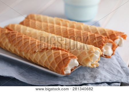 Gaufres de Montcuq, rolled wafers with cream filling  on a white dish