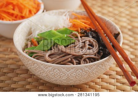 Soba noodle soup with nori seaweed sheets, green beans, carrot, and daikon radish