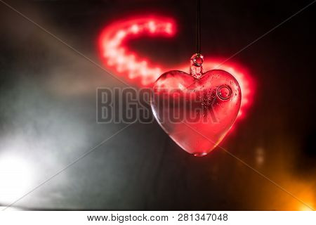 Valentines Day Concept. Glass Transparent Heart On Dark. Crystal Heart In The Dark, Glass Heart Glow