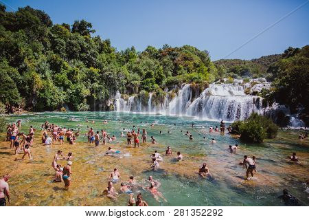 Krka National Park, Croatia - Aug 13, 2015: Plenty Of Tourists Enjoy Swimin In Krka Waterfalls In Th