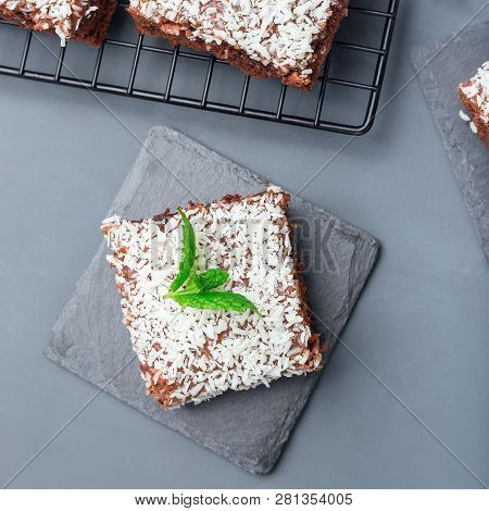 Homemade Brownie With Coconut Flakes, Swedish Dessert Karleksmums, Cut In Square Servings, On A Ston