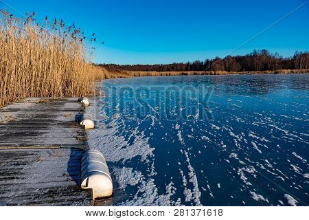 Wooden Jetty With Reed On A Sunny Winter Day