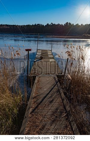 Wooden Jetty With Reed On A Sunny Winter Day