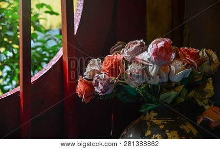 Artificial Flowers With The Wooden Window Of Rural House In Hoi An Ancient Town, Vietnam.